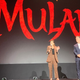 Mulan director Niki Caro, and Disney executive Sean Bailey, on stage at the D23 Expo.